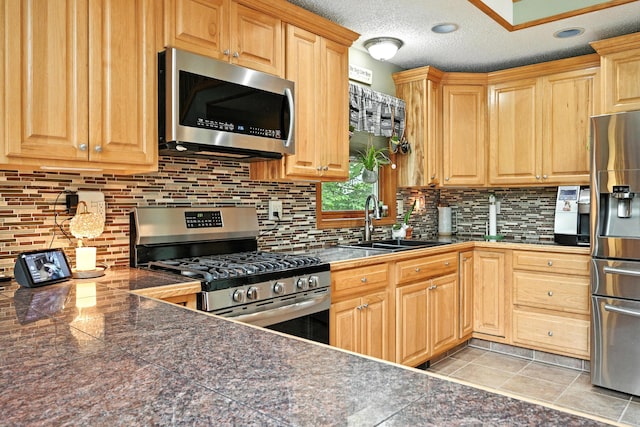146 Lone Indian Trl, Augusta, ME 04330 - kitchen featuring stainless steel appliances, tile counters, decorative backsplash, and light brown cabinets
