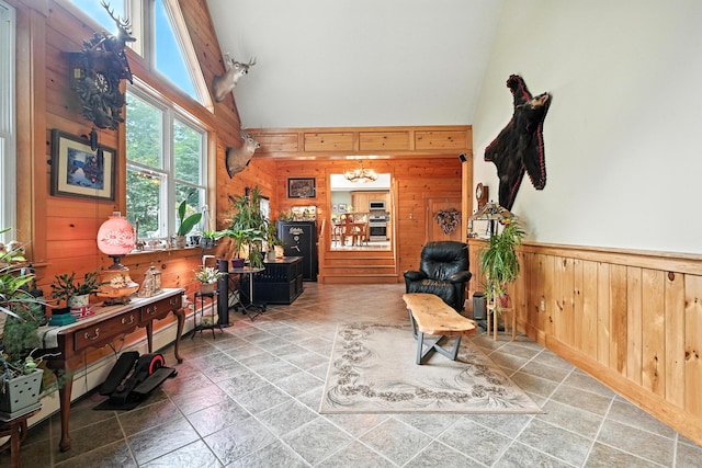 146 Lone Indian Trl, Augusta, ME 04330 - sitting room featuring high vaulted ceiling, wood walls, stone finish flooring, and wainscoting
