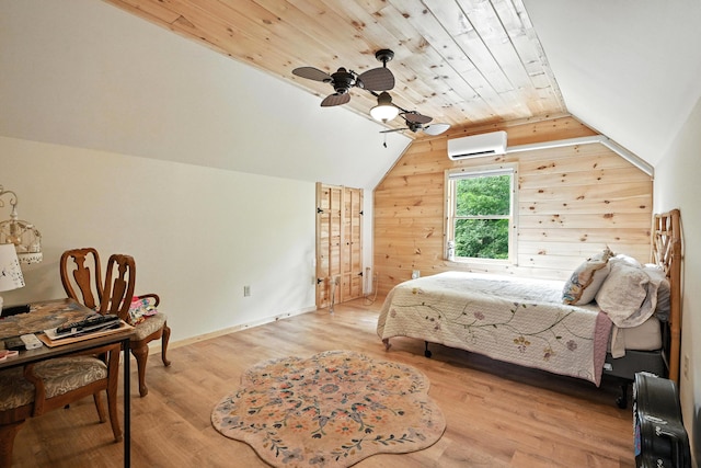 146 Lone Indian Trl, Augusta, ME 04330 - bedroom featuring a wall mounted air conditioner, light wood-style floors, vaulted ceiling, wood walls, and a ceiling fan
