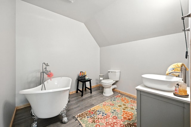 146 Lone Indian Trl, Augusta, ME 04330 - full bath with vanity, a freestanding bath, wood finished floors, and vaulted ceiling