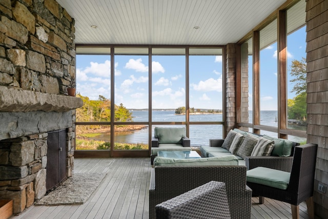 10 Cromwell Cove Rd, Harpswell, ME 04079 - sunroom / solarium with floor to ceiling windows, a water view, wood-type flooring, and an outdoor living space with a fireplace
