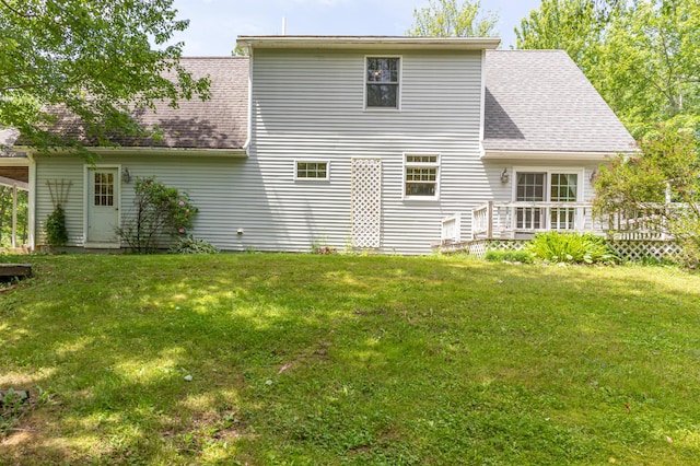 26 Spruce St, Bucksport, ME 04416 - back of property with a deck, roof with shingles, and a lawn