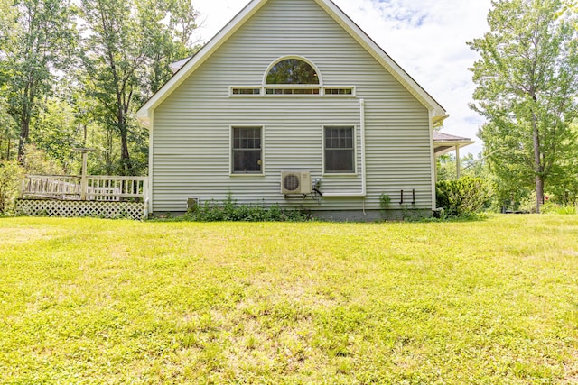 26 Spruce St, Bucksport, ME 04416 - view of side of home with a lawn and a wooden deck