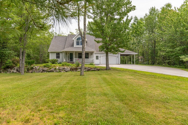 26 Spruce St, Bucksport, ME 04416 - new england style home featuring asphalt driveway, covered porch, a front lawn, a garage, and a carport
