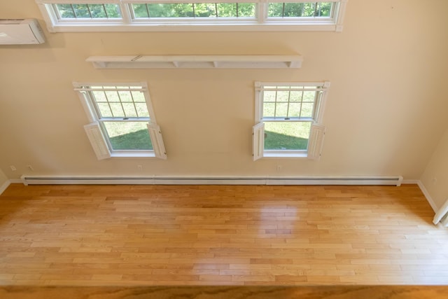 26 Spruce St, Bucksport, ME 04416 - empty room featuring wood finished floors and a baseboard heating unit