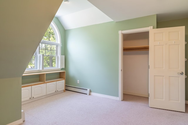 26 Spruce St, Bucksport, ME 04416 - unfurnished bedroom featuring a baseboard heating unit, light carpet, lofted ceiling, and a closet