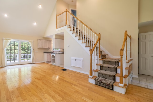 26 Spruce St, Bucksport, ME 04416 - stairs with high vaulted ceiling, wood finished floors, and recessed lighting