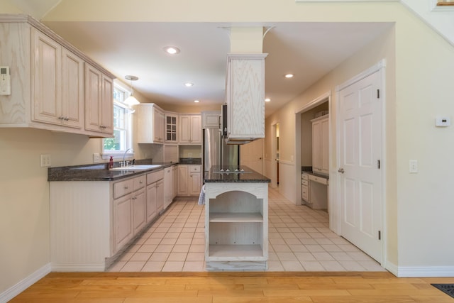 26 Spruce St, Bucksport, ME 04416 - kitchen featuring open shelves, light wood finished floors, glass insert cabinets, recessed lighting, and decorative light fixtures