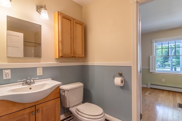 26 Spruce St, Bucksport, ME 04416 - bathroom featuring baseboard heating, vanity, and wood finished floors