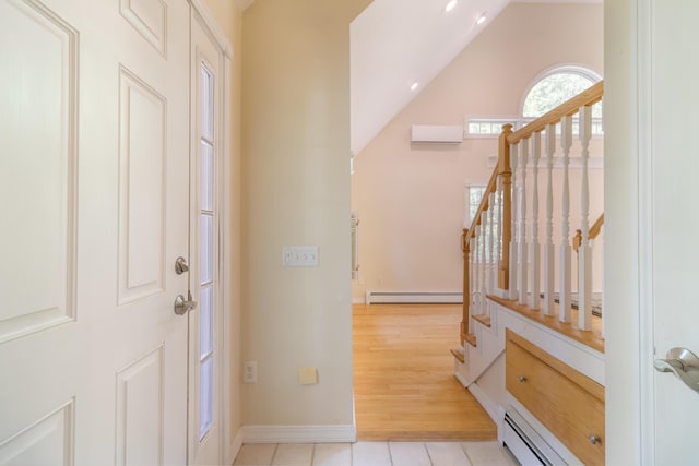 26 Spruce St, Bucksport, ME 04416 - entryway featuring a baseboard radiator, stairs, an AC wall unit, lofted ceiling, and light tile patterned floors