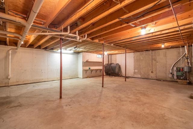 26 Spruce St, Bucksport, ME 04416 - unfinished basement featuring oil tank and a heating unit