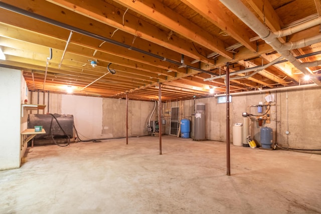 26 Spruce St, Bucksport, ME 04416 - unfinished basement featuring oil tank, a water pressure tank, a water softener system, and electric water heater