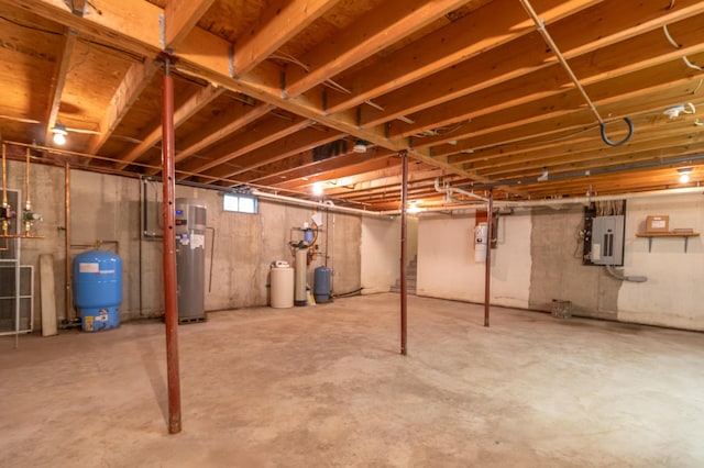 26 Spruce St, Bucksport, ME 04416 - basement featuring a water pressure tank, electric panel, water heater, and a water softener system
