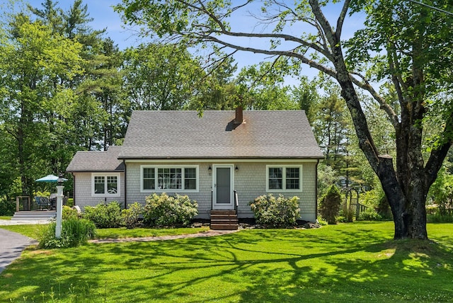 10 Burnell Dr, Yarmouth, ME 04096 - view of front facade with entry steps, roof with shingles, a front lawn, and a chimney