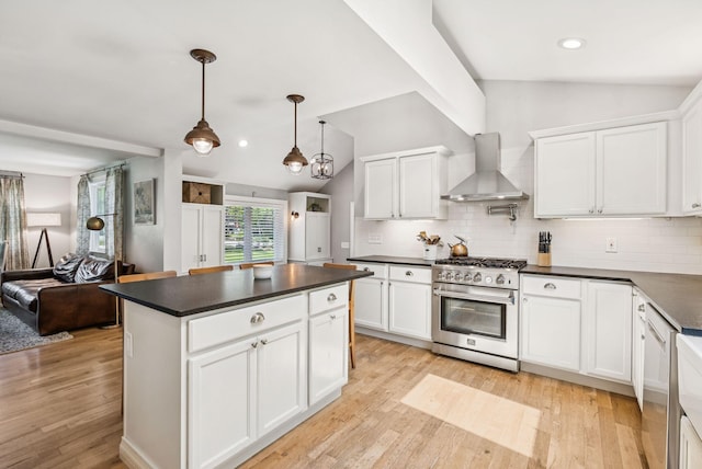 10 Burnell Dr, Yarmouth, ME 04096 - kitchen featuring wall chimney exhaust hood, stainless steel range, dark countertops, vaulted ceiling, and decorative backsplash