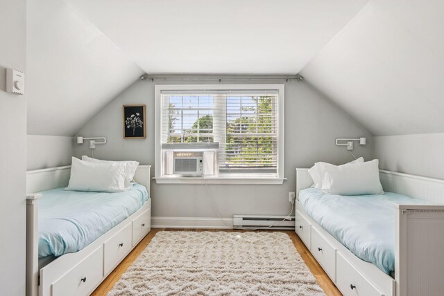 10 Burnell Dr, Yarmouth, ME 04096 - bedroom featuring baseboard heating, vaulted ceiling, light wood-type flooring, and cooling unit