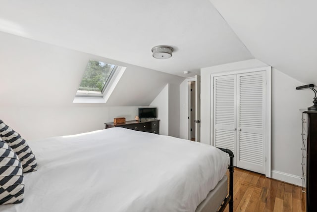 10 Burnell Dr, Yarmouth, ME 04096 - bedroom with a skylight, lofted ceiling, wood finished floors, and a closet