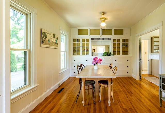 21 Elm St, Belfast, ME 04915 - dining area with ornamental molding and hardwood / wood-style floors