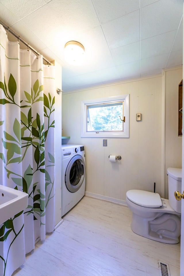 21 Elm St, Belfast, ME 04915 - bathroom with washer / clothes dryer, wood finished floors, and a shower with shower curtain