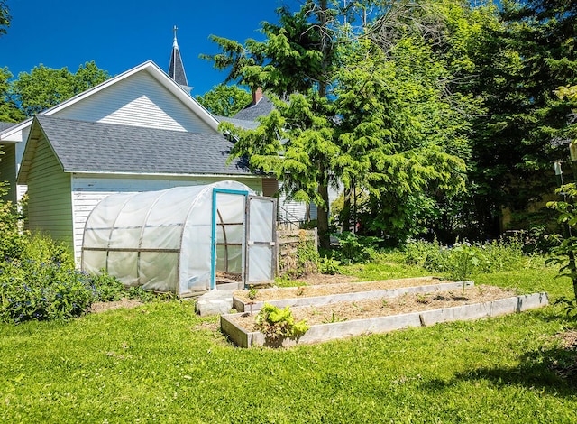 21 Elm St, Belfast, ME 04915 - view of property exterior with an exterior structure, a shingled roof, a lawn, and an outdoor structure