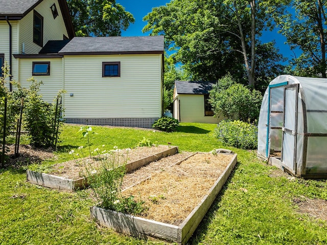 21 Elm St, Belfast, ME 04915 - view of grassy yard with a garden, an exterior structure, and an outdoor structure