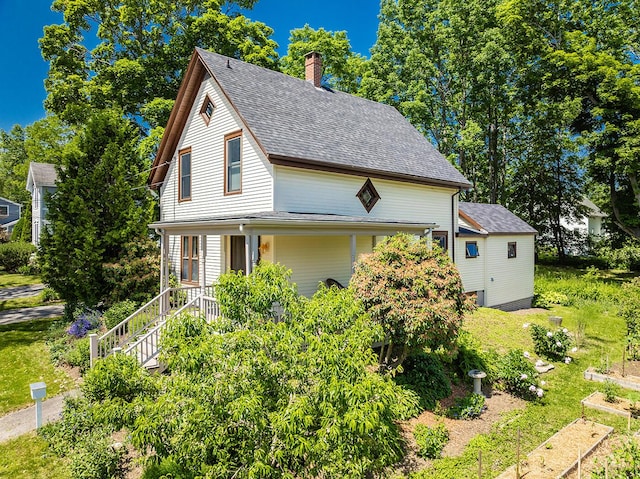 21 Elm St, Belfast, ME 04915 - view of front facade featuring roof with shingles and a chimney