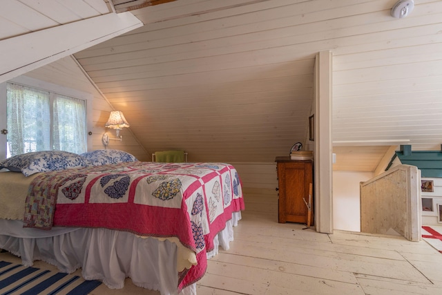 13 Gross Neck Rd, Waldoboro, ME 04572 - bedroom with wooden walls, light wood finished floors, and lofted ceiling