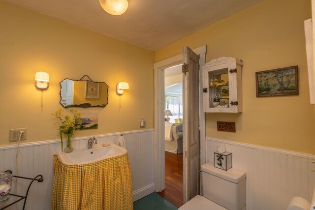 13 Gross Neck Rd, Waldoboro, ME 04572 - half bath with wainscoting, vanity, wooden walls, and wood finished floors