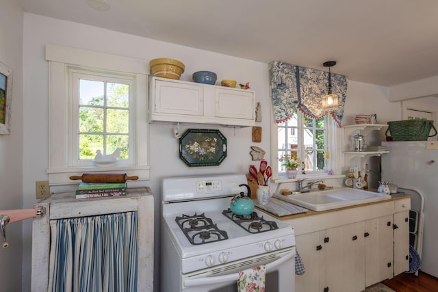 13 Gross Neck Rd, Waldoboro, ME 04572 - kitchen with white appliances, light countertops, white cabinets, and hanging light fixtures
