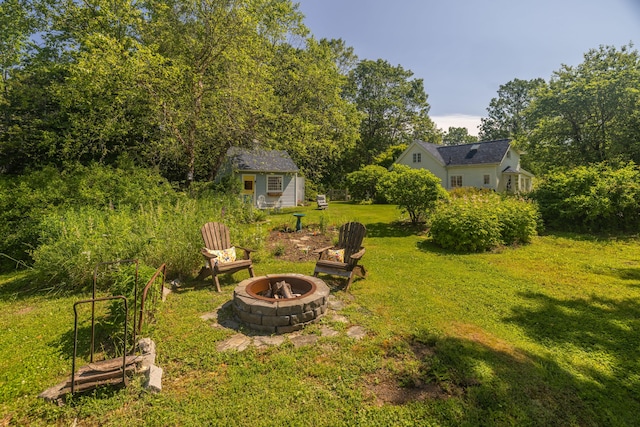 13 Gross Neck Rd, Waldoboro, ME 04572 - view of grassy yard with a fire pit and an outbuilding
