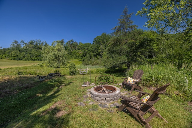 13 Gross Neck Rd, Waldoboro, ME 04572 - view of grassy yard featuring an outdoor fire pit and a view of trees