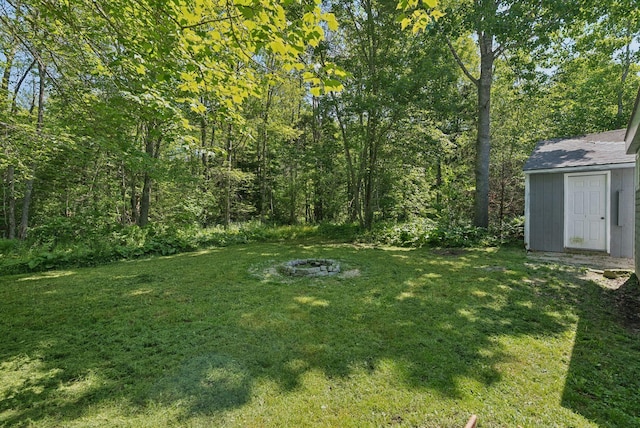 226 Seal Harbor Rd, Saint George, ME 04859 - view of green lawn with an outdoor fire pit and a storage shed