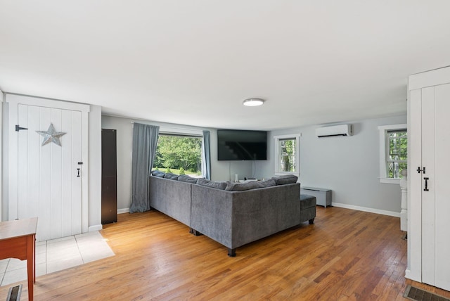 226 Seal Harbor Rd, Saint George, ME 04859 - living area featuring a wall unit AC, light wood-style floors, and a baseboard heating unit