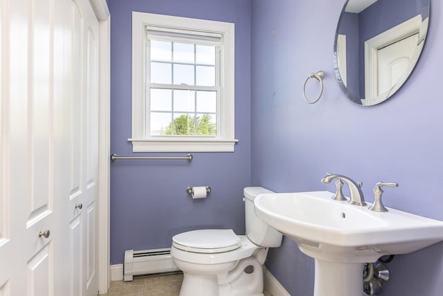 86 Allison Ave, Portland, ME 04103 - half bathroom with a baseboard heating unit and tile patterned flooring