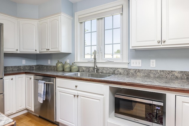 86 Allison Ave, Portland, ME 04103 - kitchen with appliances with stainless steel finishes, white cabinetry, and dark countertops