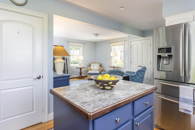 86 Allison Ave, Portland, ME 04103 - kitchen featuring stainless steel fridge with ice dispenser, blue cabinetry, a center island, open floor plan, and light countertops