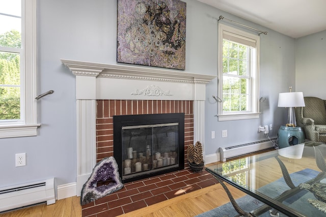 86 Allison Ave, Portland, ME 04103 - detailed view of baseboard heating, a fireplace, and wood finished floors