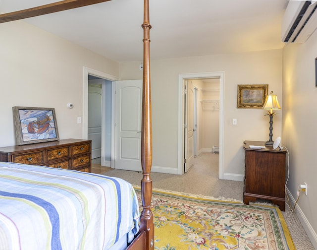 86 Allison Ave, Portland, ME 04103 - carpeted bedroom featuring a wall mounted air conditioner, a baseboard radiator, and a walk in closet