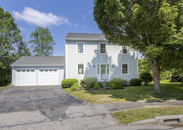 86 Allison Ave, Portland, ME 04103 - colonial-style house featuring asphalt driveway, a front lawn, a garage, and a shingled roof