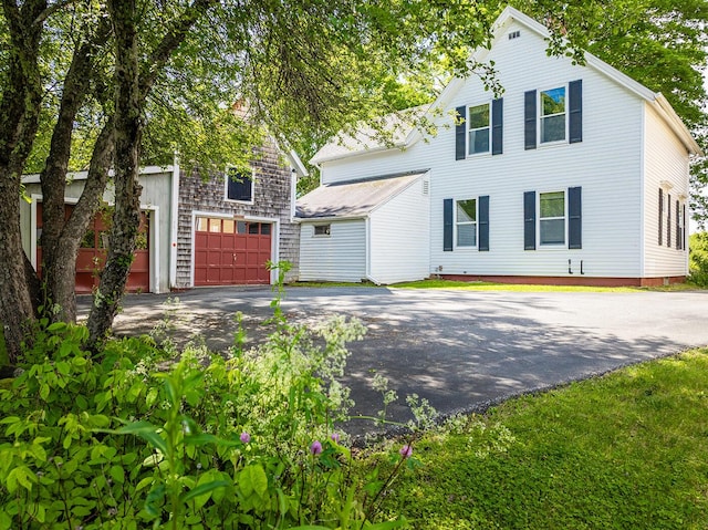 131 Russell Ave, Rockport, ME 04856 - view of front of property with asphalt driveway and a garage
