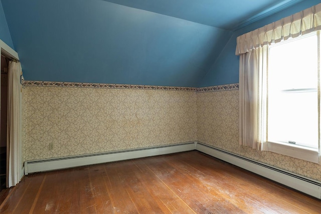 131 Russell Ave, Rockport, ME 04856 - empty room featuring vaulted ceiling, hardwood / wood-style flooring, a wainscoted wall, and a baseboard radiator