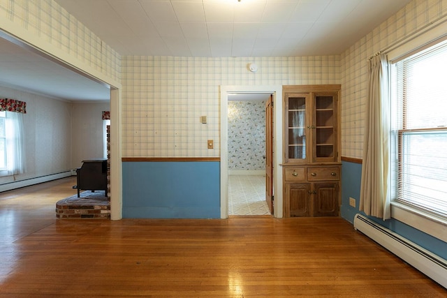 131 Russell Ave, Rockport, ME 04856 - unfurnished room with a baseboard radiator, hardwood / wood-style flooring, and wallpapered walls