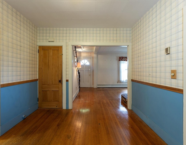 131 Russell Ave, Rockport, ME 04856 - hall featuring baseboard heating, wallpapered walls, and hardwood / wood-style floors