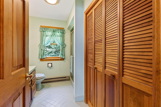 176 Perkins Beach Rd, Wayne, ME 04284 - full bath with a baseboard heating unit, a closet, vanity, tile patterned floors, and a shower