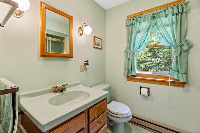 176 Perkins Beach Rd, Wayne, ME 04284 - bathroom featuring a baseboard radiator and vanity