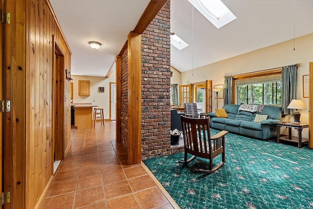 176 Perkins Beach Rd, Wayne, ME 04284 - living area featuring a skylight, light tile patterned flooring, and high vaulted ceiling