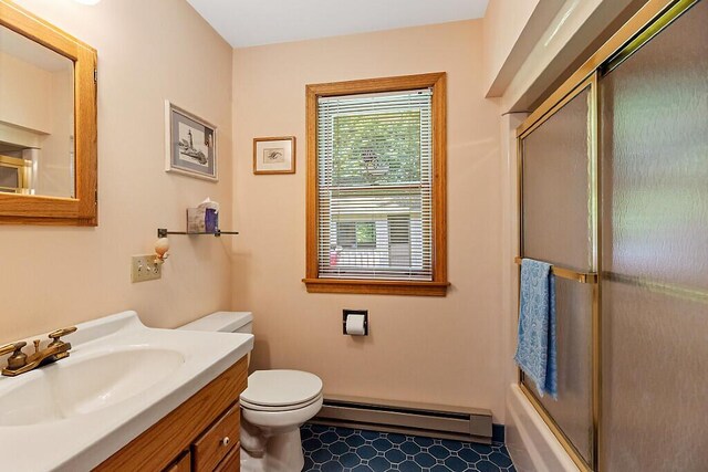 176 Perkins Beach Rd, Wayne, ME 04284 - bathroom with a baseboard radiator, vanity, and bath / shower combo with glass door