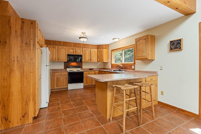176 Perkins Beach Rd, Wayne, ME 04284 - kitchen with white appliances, a peninsula, a breakfast bar, and light countertops