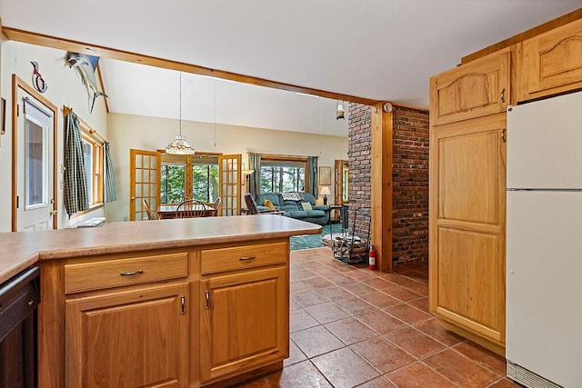 176 Perkins Beach Rd, Wayne, ME 04284 - kitchen with freestanding refrigerator, dishwasher, light countertops, hanging light fixtures, and brick wall