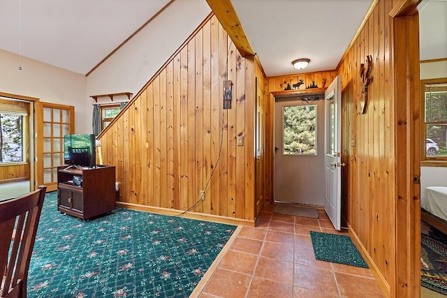 176 Perkins Beach Rd, Wayne, ME 04284 - tiled foyer entrance with wood walls, vaulted ceiling, and stairs